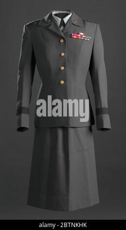 Womens US Army Service uniform worn by Brigadier General Hazel JohnsonBrown. Military dress uniform comprised of a jacket with service ribbons and insignia (.1a-f), a skirt (.2), a blouse with insignia (.3a-d), a beret with insignia (.4ab), and a hat with insignia (.5abc). Stock Photo