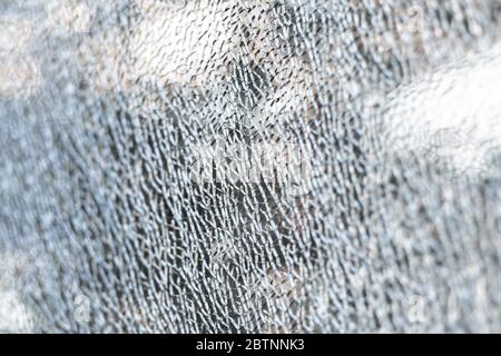 Broken tempered glass. Cracked glass web close up. Stock Photo