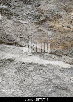 Gray stone wall background, mosaic stonewall rubble facade closeup texture cement Stock Photo