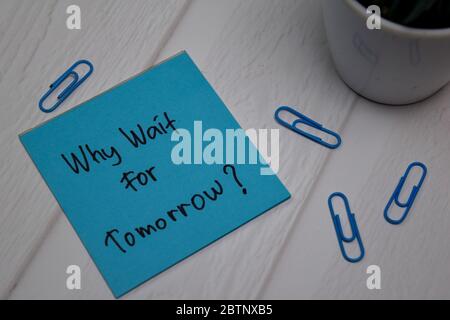 What Wait For Tomorrow write on sticky note isolated on wooden table. Stock Photo
