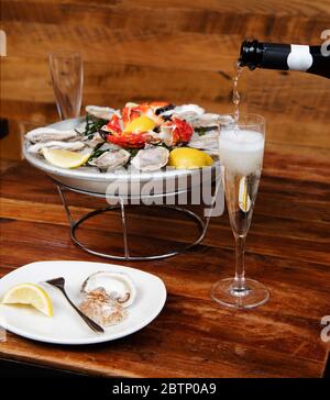 Seafood platter and champagne being poured Stock Photo