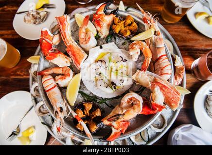 Seafood platter with oysters, clams, langoustines, lobster, shrimp and crab legs Stock Photo
