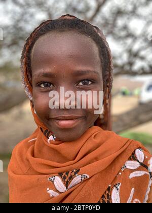 Beautiful baby girl with traditional hijab muslim head wrap, Afar Region, Ethiopia, Africa Stock Photo