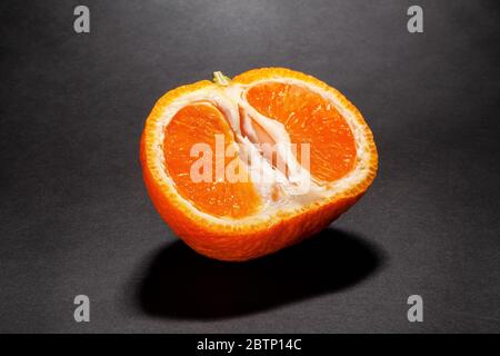 sliced tangerine on black background Stock Photo