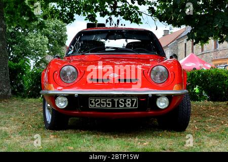 An Opel GT car from 1971 parked on grass at a classic car show in rural France Stock Photo