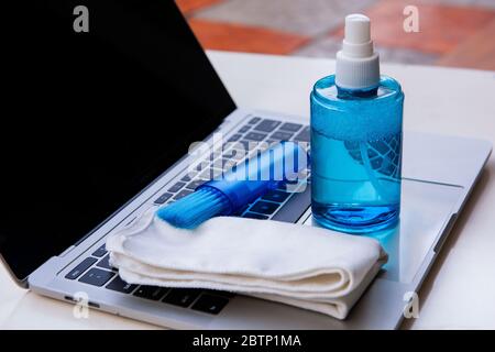 Laptop cleaning up. Service for cleaning notebook screen, keyboard, case. Cleaning accessories: brush, cloth, spray. Computer monitor Stock Photo
