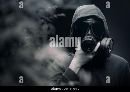 A man wearing a gas mask  and the gloomy atmosphere Stock Photo