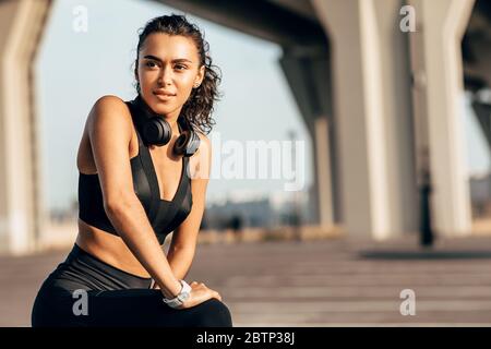 Beautiful fit woman stretching her legs before training Stock Photo
