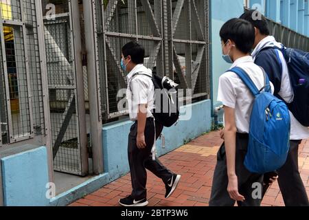 Hong Kong. 27th May, 2020. Students enter a middle school in Tsuen Wan in the western New Territories of south China's Hong Kong, May 27, 2020. Schools in Hong Kong will gradually reopen since Wednesday as previously announced. Credit: Lo Ping Fai/Xinhua/Alamy Live News Stock Photo