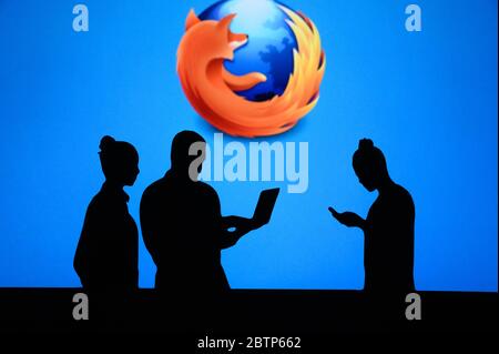 NEW YORK, USA, 25. MAY 2020: Mozilla Firefox web browser Group of business people chat on mobile phone and laptop. Company logo on screen in backgroun Stock Photo