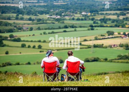 Brighton UK 26th May 2020: A couple enjoying the fabulous views over the Sussex Weald at Devil's Dyke in the South Downs National Park in Sussex on a Stock Photo