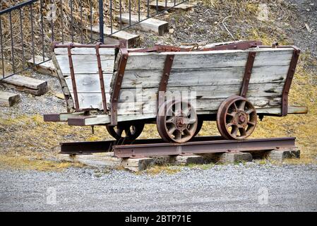 A mining cart from the early 1900's riding on rails built to remove ore from the coal mine shaft in Cadomin Alberta Canada Stock Photo