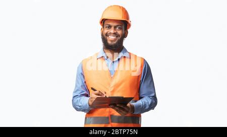 Happy Construction Worker Guy Taking Notes Holding Folder, Studio Shot Stock Photo