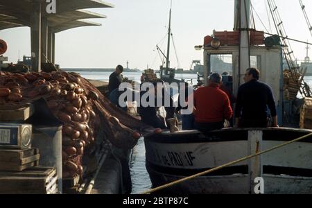 Fishermen and a fishing trawler in the old harbour of Marseille in France pictured in 1967 Stock Photo