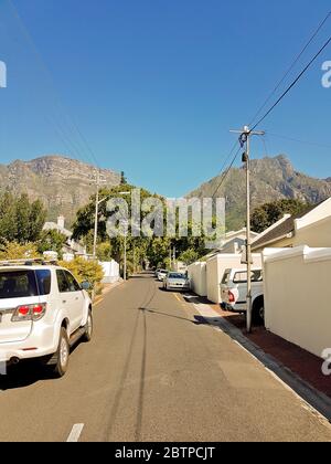 Street in the town of Claremont, Cape Town, South Africa. Sunny weather and panorama of Table Mountains. Stock Photo