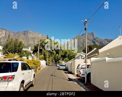 Street in the town of Claremont, Cape Town, South Africa. Sunny weather and panorama of Table Mountains. Stock Photo