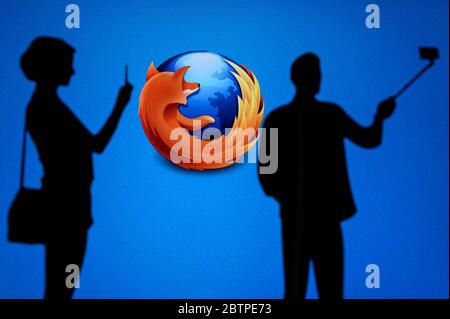 NEW YORK, USA, 25. MAY 2020: Mozilla Firefox web browser Man and Woman taking a photo on mobile man use selfie stick. Company logo on screen in backgr Stock Photo