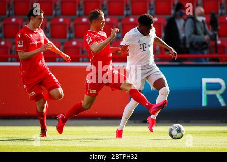 FC Union Berlin's Marcus Ingvartsen in action with Bayern Munich's Alphonso Davies, right, during the German Bundesliga soccer match between Union Berlin and Bayern Munich in Berlin, Germany. Stock Photo