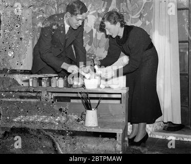 Painting a story . Prize winning art students murals for South Africa House . Miss Eleanor Esmonde White and Mr Le Roux Smith mixing the yolk of eggs with their pigments for their murals at South Africa House . 10 January 1936 Stock Photo