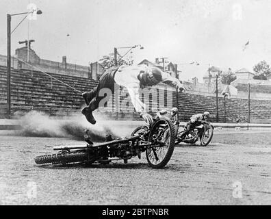 Flying spill. Poised grotesquely over his crashed machine, Peewee Cullen, the American speedway rider, was caught by the camera the instant before he hit the cinders after a bad spill during practice at the Yankee Stadium, New York. The overtaking riders were fortunately able to avoid him and he escaped with only a mouthful of cinders and a few bruises. To reduce the danger to fallen riders, red lights have been installed in every corner on the New York track to warn our other competitors when a man crashes. 13 June 1937 Stock Photo