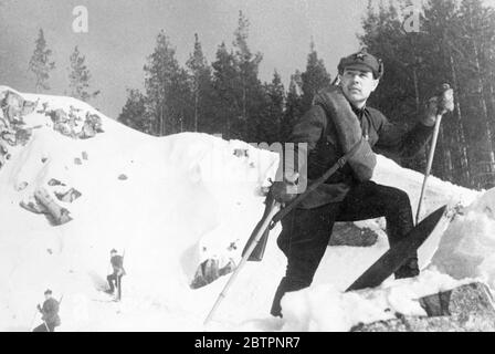 Soldiers of the snows. Red Army soldier, with the five pointed star prominent on his, blanket and rifle slung across his shoulder, gazes across the snows of the Ural Mountains during the annual Soviet military exercises. 13 February 1938 Stock Photo