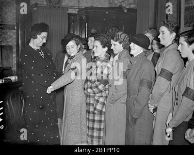 The WATS on parade. Recruits are now being enrolled for the Women's Auxiliary Territorial Service, brought into being during the recent crisis and now to be organised on the same basis as the territorial Army. Members will be used for clerical duties at the various Territorial Headquarters while Special Sections will be trained for light transport and work in cook houses and canteens. Photo shows, Company Commander Mrs Dudley Harris, issuing brassards two new recruits of the 1st County of Middlesex Company, at their headquarters at Ravenscourt Park. Armbands will be worn until the new uniforms Stock Photo