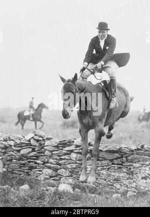 America's hunting, Minister to Eire. Mr John Cudahy , newly appointed United States Minister to Eire (Ireland) is a keen follower of the hunt and has rapidly become very popular in hunting and social circles in County Dublin. Photo shows, Mr John Cudahy , leaves his saddle as his mount takes a stone wall while out with the North Kildare Hounds at Punchestewn, Eire. 4 January 1938 Stock Photo