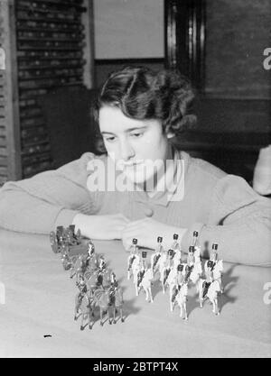'Recruits'to Britain's Christmas army. Toy models of the Royal Artillery and Scots Greys made in a factory in Hornsey Rise, London, for the Christmas market. This year, there is an unprecedented demand for toy soldiers, perhaps as a result of the governments recruiting campaign and factories are working at full pressure. 23 November 1937 Stock Photo