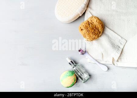 Stylish composition of accessories and cosmetics from ecological materials for bath procedures on light wood background. Flat Lay Style. Stock Photo