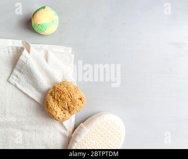 Stylish composition of accessories and cosmetics from ecological materials for bath procedures on light wood background. Flat Lay Style. Stock Photo