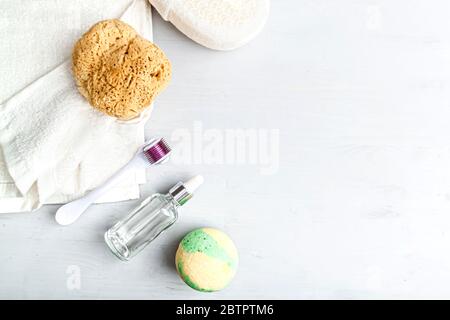 Stylish composition of accessories and cosmetics from ecological materials for bath procedures on light wood background. Flat Lay Style. Stock Photo