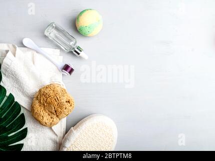 Stylish composition of accessories and cosmetics from ecological materials for bath procedures on light wood background. Flat Lay Style. Stock Photo