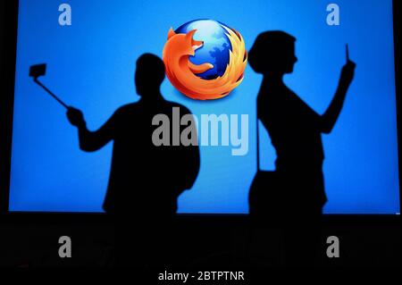 NEW YORK, USA, 25. MAY 2020: Mozilla Firefox web browser . Couple taking a photo on a mobile man use a selfie stick. Company logo on screen in backgro Stock Photo