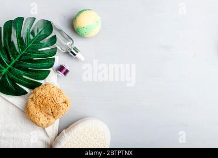 Stylish composition of accessories and cosmetics from ecological materials for bath procedures on light wood background. Flat Lay Style. Stock Photo