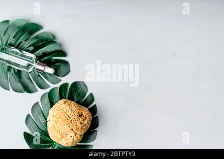 Stylish composition of accessories and cosmetics from ecological materials for bath procedures on light wood background. Flat Lay Style. Stock Photo