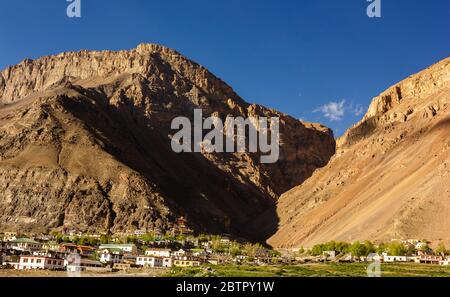 High, barren mountains rising above the village of Kaza in the Spiti Valley in HImachal Pradesh, India. Stock Photo