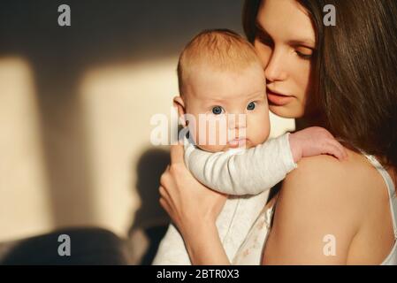 portrait of a woman with a newborn baby in her arms Stock Photo