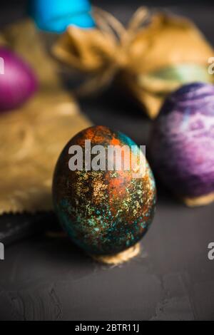 Rustic colored easter eggs on the dark stone background. Shallow depth of field. Stock Photo