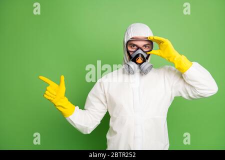 Portrait of his he nice confident professional disinfectant wearing touching fixing gas mask showing copy space quarantine restrictions news isolated Stock Photo