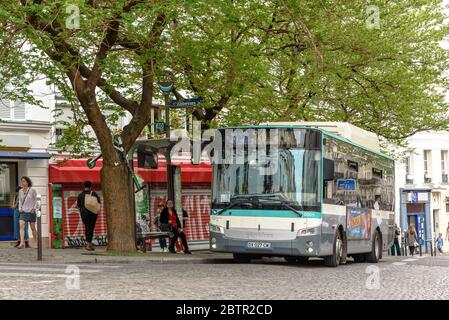 A public transport bus at the Abbesses metro station in Montmartre, Paris Stock Photo