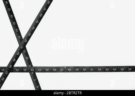 Black Measure tape isolated on white background. Weight loss, diet, overweight concept. Copy space Stock Photo