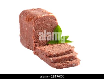sliced tinned corn beef with garnish isolated on a white background Stock Photo