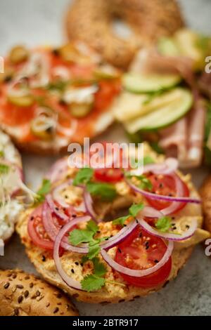 Assortment of different kinds toppings homemade bagels sandwiches with sesame and poppy seeds Stock Photo