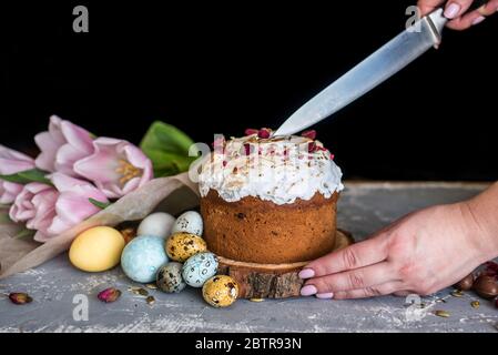 Easter composition with sweet bread, kulich and eggs on light background. Easter holidays breakfast concept. Stock Photo