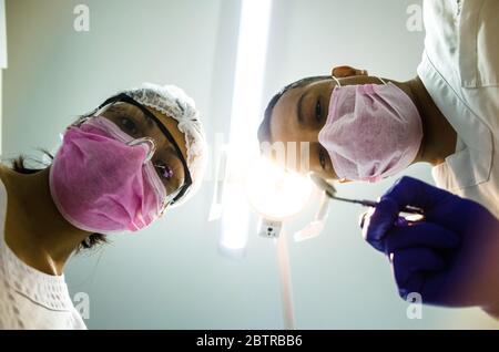 Portrait of two surgeons at work, operating in uniform, looking at the camera Stock Photo