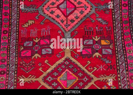 The part of turkish-azerbaijan handmade red carpet. Textures and traditional motifs, vintage textures . Part of azerbaijan handmade carpet . Baku Stock Photo