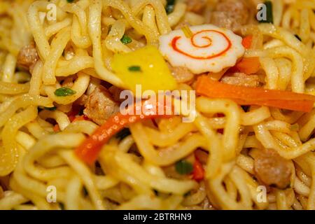 Cooked instant noodles with spices, dried vegetables and freeze-dried meat. Close up Stock Photo