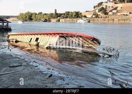 BELGRADE, SERBIA - AUGUST 15, 2012: Sunk restaurant boat in Belgrade. Sava River embankment in Belgrade is lined with multiple restaurant ships. Stock Photo