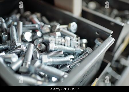 Close-up of silver screws placed in metal box, repairman or furniture maker workplace concept Stock Photo