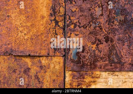 Rusted flat composite nailed metal sheets surface background and texture. Stock Photo